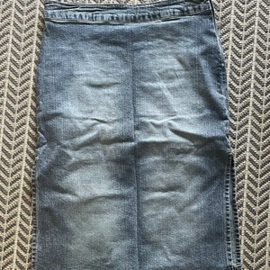 Vintage Jeanskjol - Skitfin längre jeanskjol med slits på sidorna! Baktill är jättefina äkta fickor! Stl. 36-38