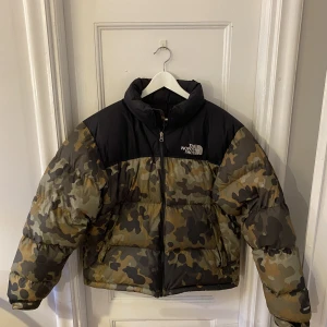 North Face Nuptse Camo Jacket - Rare pattern och riktigt bra skick. Köpt för 2 år sedan. Har använt denna väldigt lite då jag fick en annan jacka kort efter att jag köpte denna. Den har mest hängt hemma, därför säljer jag den nu. 