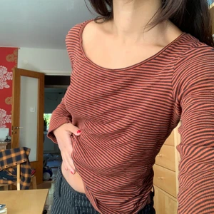 Randig tröja - En skön randig tröja i svart och röd/orange. Går att ha off-shoulder på ena axeln. Passar xs-s. ❤️