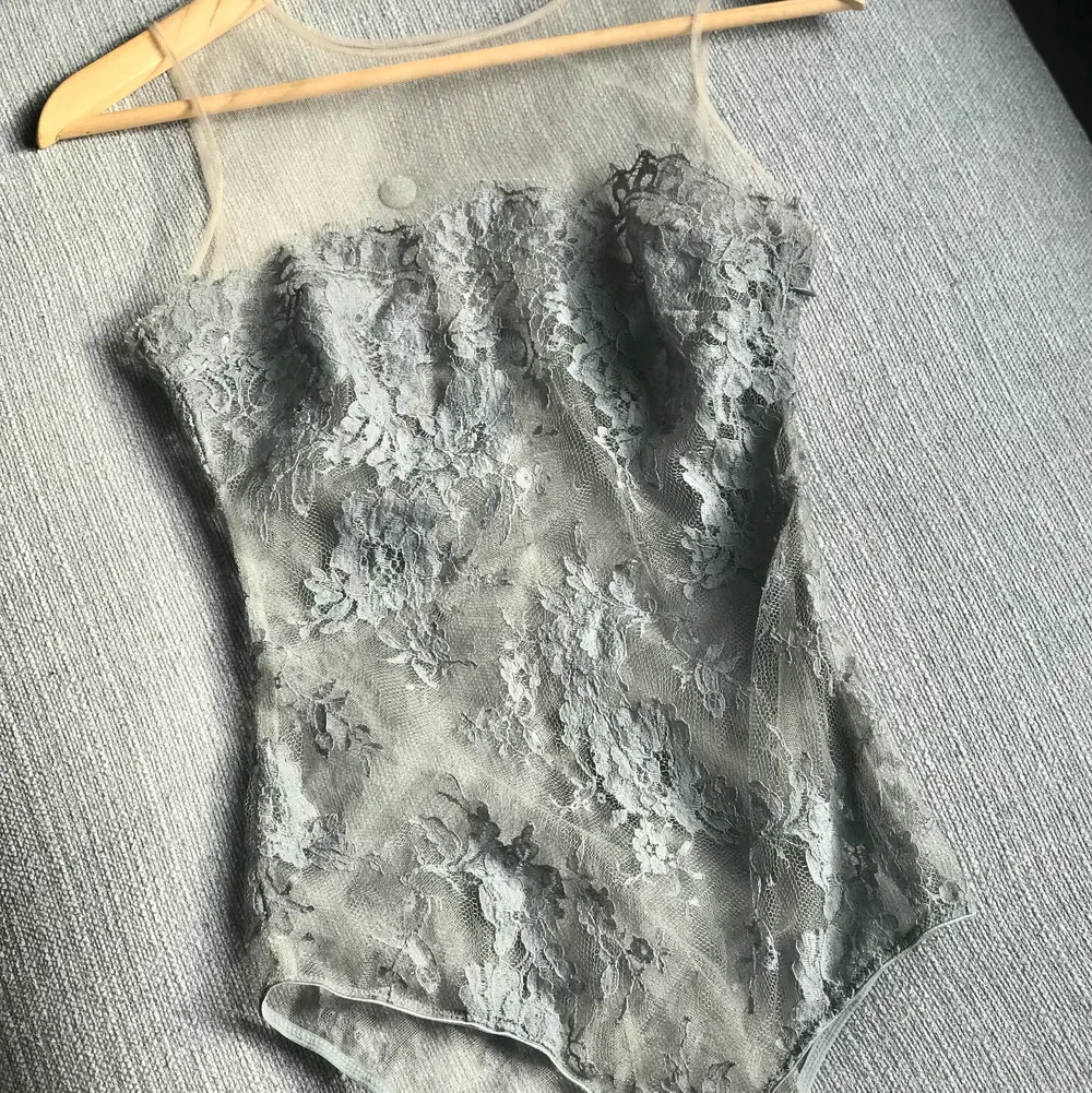 Så fin grå body/ bustier från I.D. Sarrieri  Vackra enkla kupor. Super fint på kroppen men en blixtlås på sidan. Strl: S skulle passa XS. Upplever som Em mindre mindre S.  Material: 40 % bomull, 60 % polyamid. Toppar.