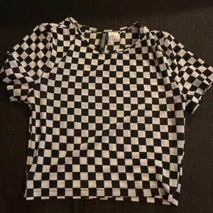 Schack mönstrig t-shirt - Köpt på h&m säljer för att den har blivit för liten. Tight, storlek xxs-xs schack mönster. MEN den är lite  genomskinlig. Så tips är att ha något under ❤️ använd ca 2 gånger ❤️frakt ingår i köpet/priset ❤️ skickas via postnord. Kontakta mig om ni har frågor❤️