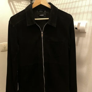 J.Lindeberg Jonah mockajacka - J.Lindeberg Jonah overshirt i mocka. Inköpt 2018, är i använt skick. Säljer eftersom jag växt ur den. Nypris 5000kr