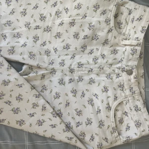 byxor designade med lila blommor - Nya byxor, köpta och använda endast en gång. Här i Solna- Stockholm.