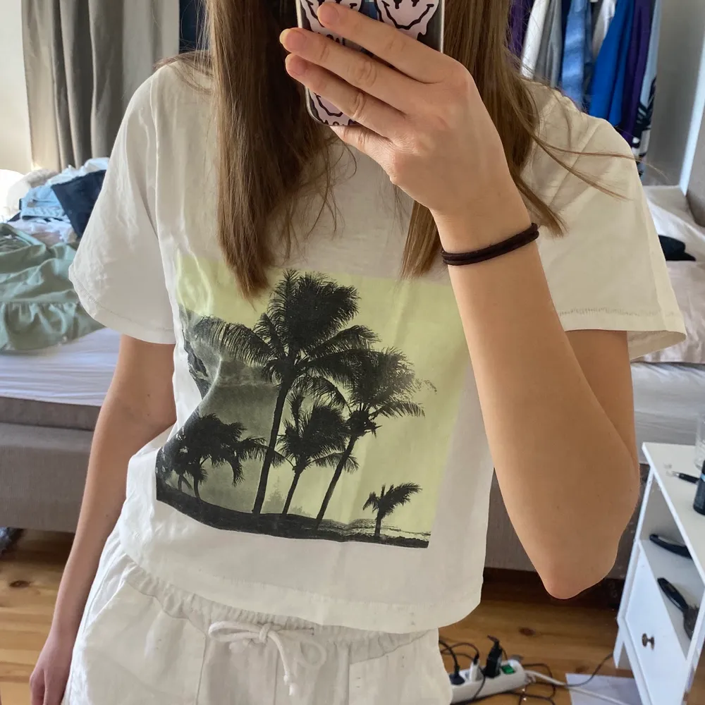 Rätt så croppad och oversized vit t-shirt med ett neongrönt tryck i mitten🤍. T-paidat.