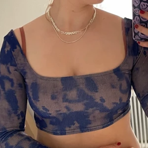 långärmad magtröja i lila/blå färg - en cool uringad magtröja, med en färg blanding utav grålila och mörkblå. Den har även en liten öppning i ryggen och går ungefär straks under bh-kanten. Vet inte vart toppen är ifrån då jag har klippt bort lappen, men skulle gissa på berskha eller weekday.