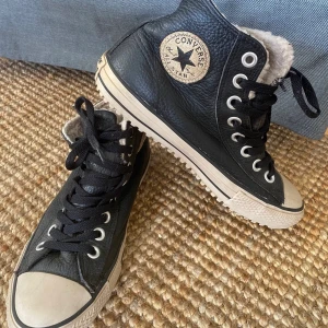 Svarta converse - Säljer nu ett par svarta läder converse som är fodrade inuti, jättebra nu till hösten/vintern. De är i storlek 40 och är en bredare modell