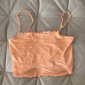 Very cute and light summery peach tank top from H&M. Never been used. Thin material but very comfortable. 
