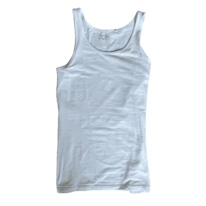Tank top, linne i storlek 158 - Ribbad topp i storlek 158, alltså barnstorlek, sitter åtsittande på mig men jag e 181,70kg kille :) definitivt använd men inga defekter och tyget är vanligt skick