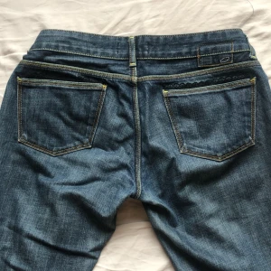 Bootcut jeans - Bootcut jeans som är Low waist med spets på fickorna, midjemåttet- ungefär 39cm 