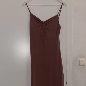 Klänning  - En underbar rosa/brun/beige klänning som passar sommaren perfekt. Den är lång och har även en slits på backsidan. Tyvärr blev den lite för stor för mig, därför har jag aldrig använt den. Frakt ingår med 29kr