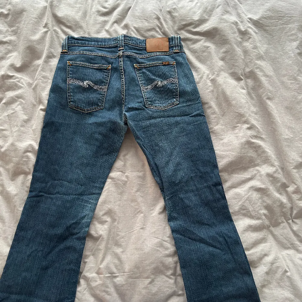 Säljer dessa supersnygga blåa bootcut jeans från nudie. De är endast använda ett få tal gånger och upplevs nya, säljer dem då jag har ett par nästan likadana. Jag är 174 cm lång. . Jeans & Byxor.