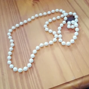 Halsband med vita pärlor. Plast - Halsband med vita pärlor plast.