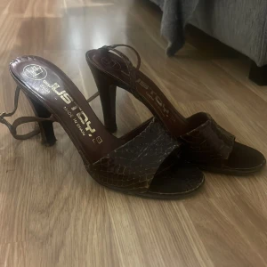 Klackar  - Mörkröda / bruna läder klackar. Köpte på en loppis, men har själv aldrig använt. Sitter som dom ska och banden runt fungerar och är inte trasiga. 