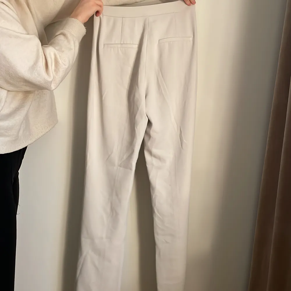 Vita kostymbyxor från Hm med slits bra skick, högmidjade och Stretchiga . Jeans & Byxor.