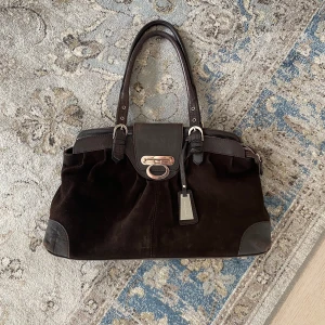 Vintage Väska - Säljer nu denna vintage väskan i mocka och skinn! Perfekt till alla tillfällen! Den rymmer böcker, dator och passar därför även bra som skolväska. Fråga gärna för fler bilder🤎