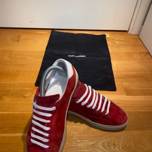 Saint Laurent skor SL06 - Tja säljer as feta röda Saint Laurent skor. Storlek 40-41(om man tar av sulan kan den även passa 42. De är i ok skick 7.5/10. Nypris 6000 mitt pris 1700 defekt:saint Laurent logga borta på båda sulorna (sista bild)