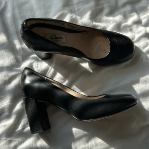 clarks klackar  - Jag säljer ett par svarta Clarks klackar i storlek 38. De är i mycket fint skick men har några skav på ena hälen samt lite klister fläckar inuti skorna, de borde dock inte vara några problem att tvätta bort.
