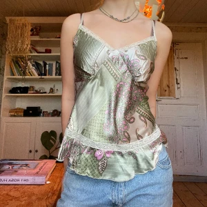 Topp med spets 2000s - Grön topp med blommor och spets. Silkesliknande material och i fint skick, behöver bara strykas. Så fin!