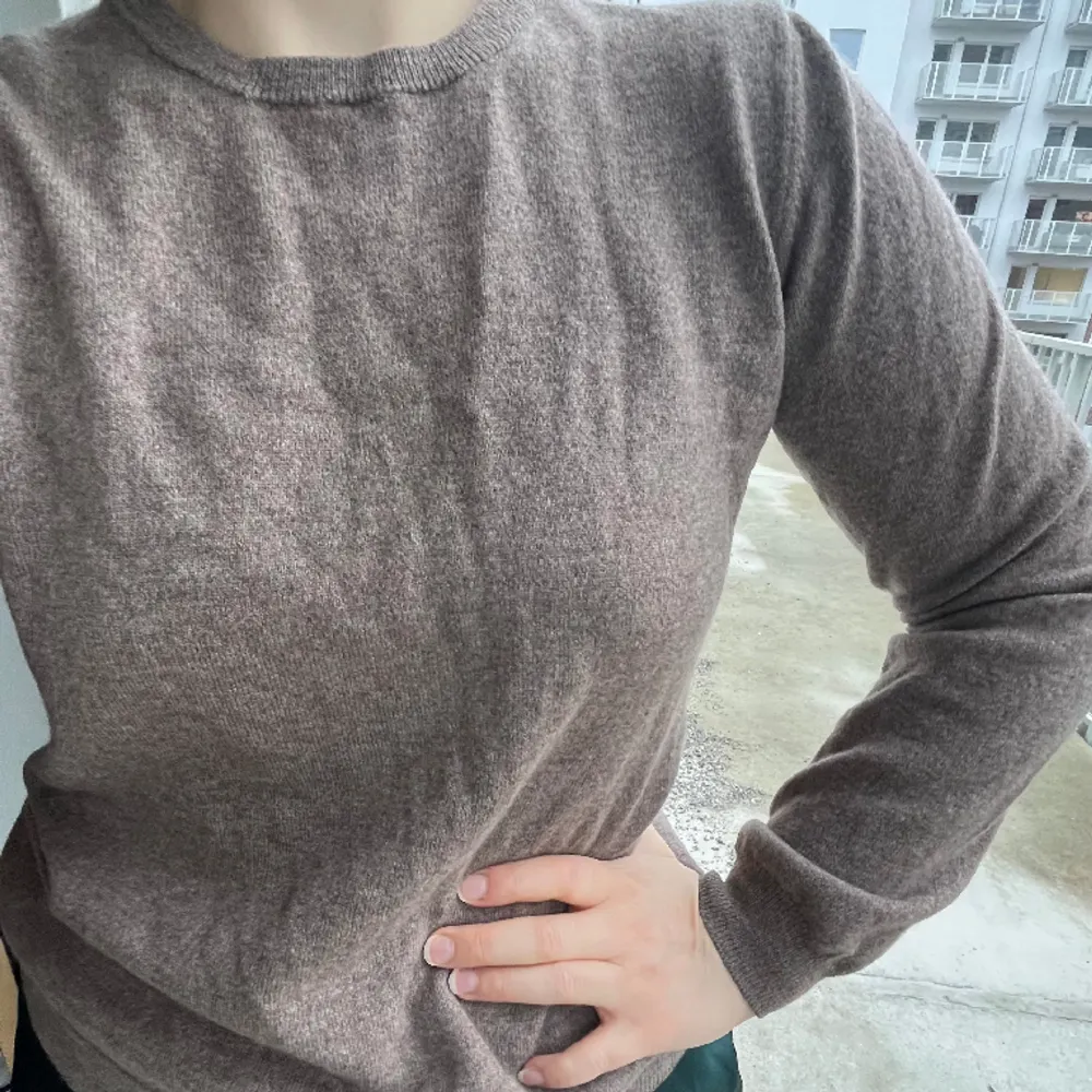 J. Lindeberg, stickad crewneck-tröja i storlek m. 70% super fine merino wool. 30% cashmere/kashmir. FĂ€rg mellan beige och brunt, lite melerad. Finns ett litet hĂ„l frampĂ„ som lĂ€tt gĂ„r lagas med nĂ„gra stygn, inga maskor har slĂ€ppt. Köpt secondhand âïž. Neuleet.