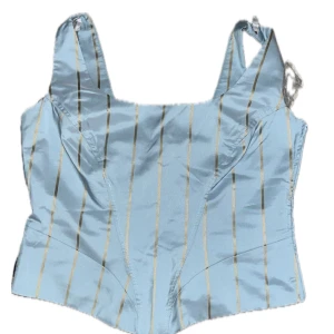 Korsett topp - Fin blå korsett topp med gulddetaljer, bra skick inga defekter, jag har alldrig använt den! 