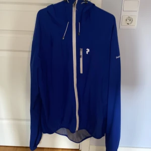 Peak Performance Regnjacka - Riktigt snygg jacka från Peak Performance. Knappt använd. Storlek XL men passar L Skick 9/10 en gummibit som saknas på dragkedjan.
