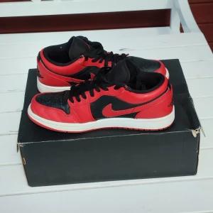 Nike Jordan 1 Retro Low Reverse Bred (553558-606) - Ett par begagnade Jordans i bra skick, har små tecken på användning! Kolla gärna mina bilder för referens :)  Storlek: USA 8 41 EUR UK 7  Meddela mig jättegärna om du har några frågor :) Skickas med en Jordan kartong, dock ej orginalet!