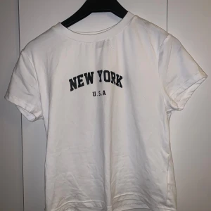 Vit t-shirt med tryck - Axelbred: 35 Cm Längd: 50 Cm Väldigt stretchigt och mjukt tyg! Aldrig använd