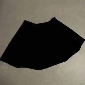 En svart kort kjol från Ginatricot, strl står ej men skulle säga att det är en S!