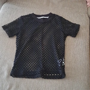 Top - A very elegant and classy black top. That have holes in it. It was made like this.  Can wear it with many shirts under it. 100% new.