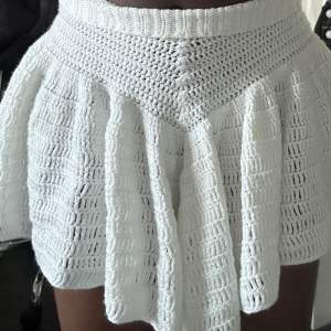 Crochet short ruffle skirt with adjustable waistband. 