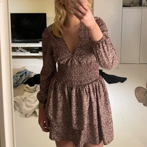 Klänning  - Klänning med volanger och blommor 