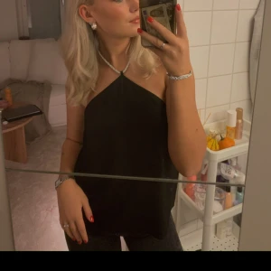 Topp med glitter detalj  - Superfin ”halterneck” topp med glitter band!! Superfin topp men kommer inte till användning för mig! 🖤