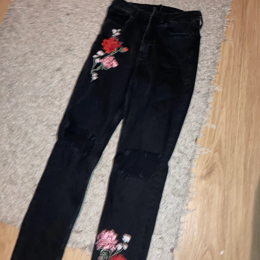 Super fina Mom jeans från hm med hål på knäna och tryck med blommor , storlek 36. Jeans & Byxor.
