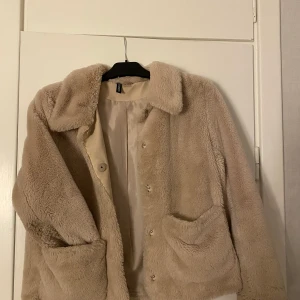 Beige pälsjacka  - Mysig pälsjacka i ljus beige, ganska kort modell. Med knappar och två fickor på framsidan🦋🦋