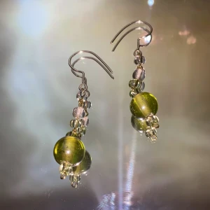 Örhängen - Ett par handgjorda örhängen med gröna glaspärlor✨ kroken är av silvertråd, och frakten ingår i priset❣️