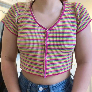  - Crop top i regnbågens färger, liknar UNIF’s ”Rit Top” Kan skicka fler bilder! Frakt tillkommer💞🌈 OBS!!! Knapparna går ej att knäppa upp, om man inte byter ut dem :)