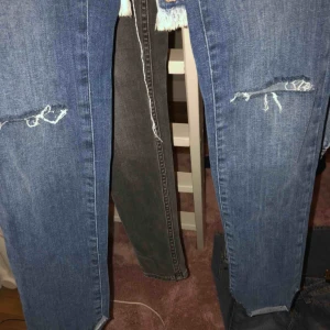  - Jeans från bikbok med små hål på knäna och ojämnt längst ner. 