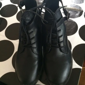  - Snygga skor från Märket Top Shop.
Köpta i London för två år sedan. Skorna är i gott skick. Säljer pga garderobrensning.
Svarta i skinnimitation, snygga detaljer.
Frakt tillkommer. 