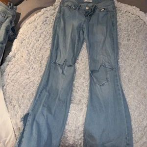 Blåa boot cut byxor - Ljusblåa bootcut med slits och hål i knäna, skitsnygga men inte min stil tyvärr. Aldrig använda 💕 storlek 36