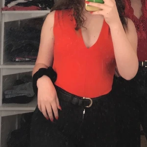 Röd body - Strl XS. Fin röd body med v-ringning vid bröstet. Säljer denna då den bara har kommit till användning en gång. 🥰 Köpare betalar frakt!