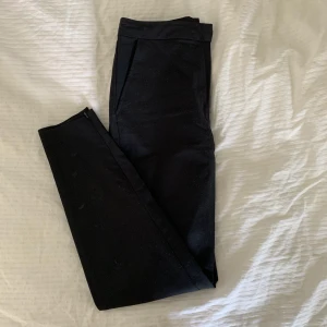 Svarta kostymbyxor - Jätte fräscha kostymbyxor från Bik Bok. Säljer pga. Att dom sällan används. Dragkedja längst ner på vaden. Knäppa med gylf, knapp och en liten metallhakare. Jättefint skick