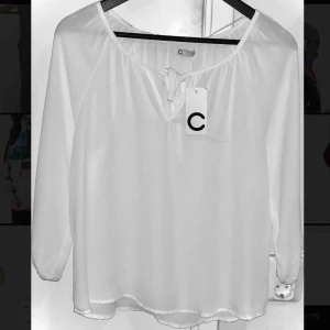  - Vit blus fån cubus, strl 34. Oanvänd, prislapp finns kvar.