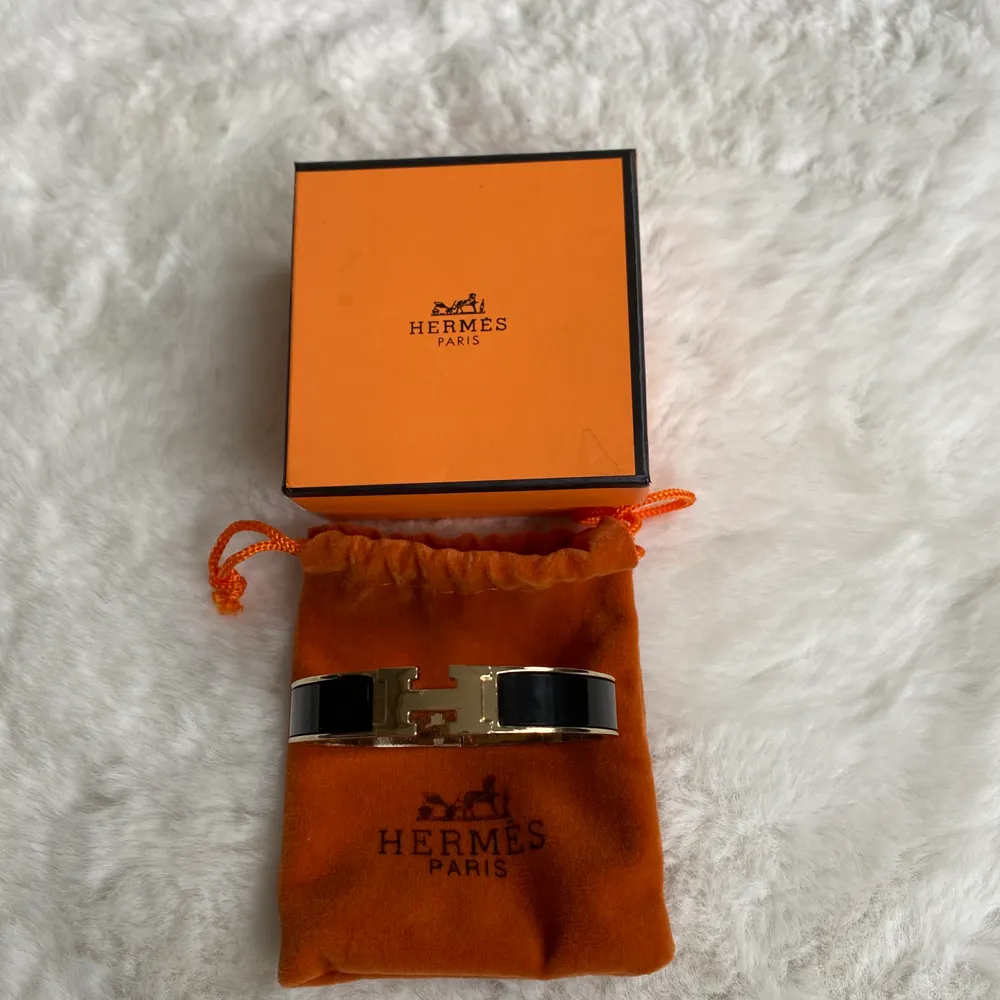 Hermes armband oäkta men väldigt fin i svart/guld  köparen betalar frakt om den skickas .. . Accessoarer.