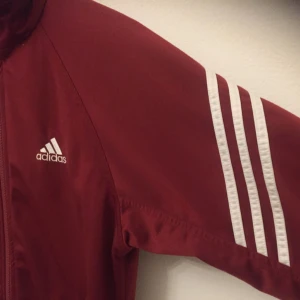  - Lite ovanlig Adidas-jacka. 2 fickor framtill med dragkedja.