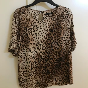 Leopard blus i stl 38  - Säljer en alldeles ny topp från NAKD i stl 38 pga ingen användning. 