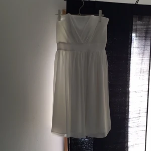  - Vit plisserad klänning från H&M utan axelband. Perfekt till student, konfirmation , midsommar eller annan tillställning som sommaren kan komma att erbjuda. Använd en gång. 