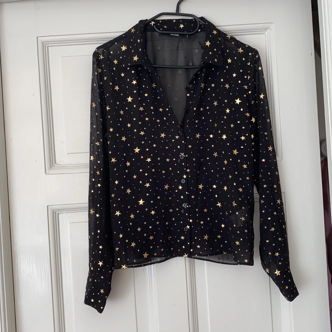 Glittrig blus med stjärnor