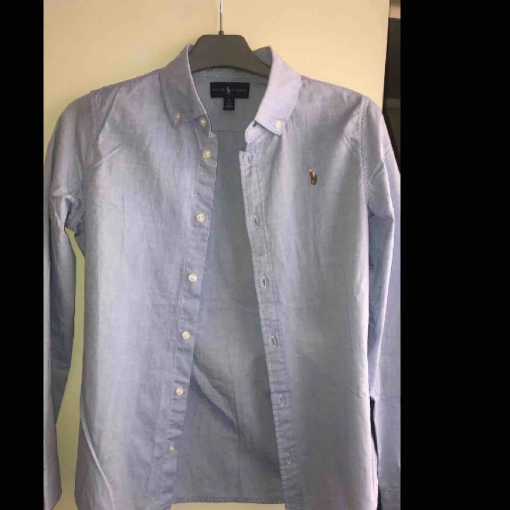 En ljusblå skjorta från Ralph lauren💙Oanvänd! pga fel storlek för mig:) pris kan diskuteras💙frakt står köparen för:) kram❤️ . Skjortor.