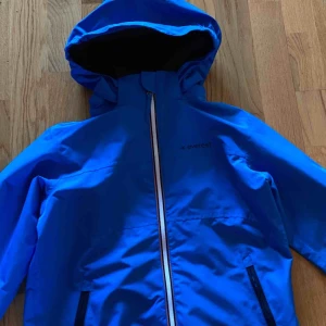  - Blå regnjacka/vindjacka från Everest i nyskick, storlek 134.