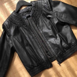 Svart skinnjacka - Supersnygg skinnjacka med fina detaljer. Sparsamt använd och är som ny. 